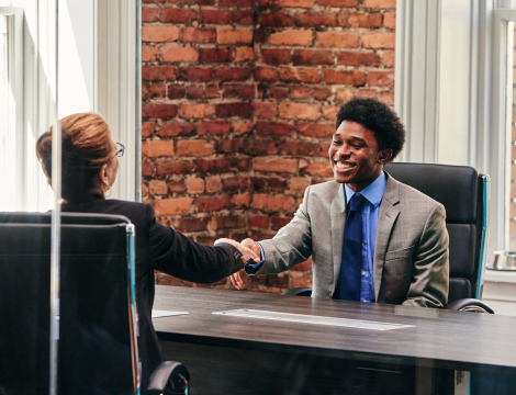 Business man smiling and shacking hands