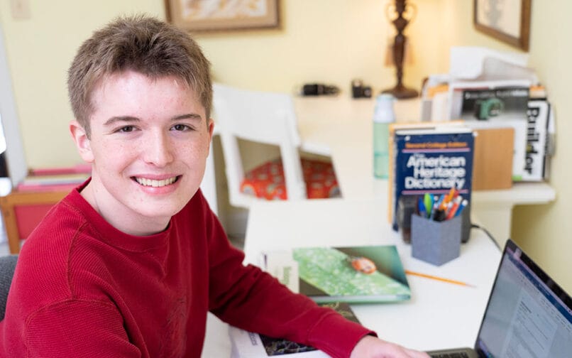 Student working with his laptop at home